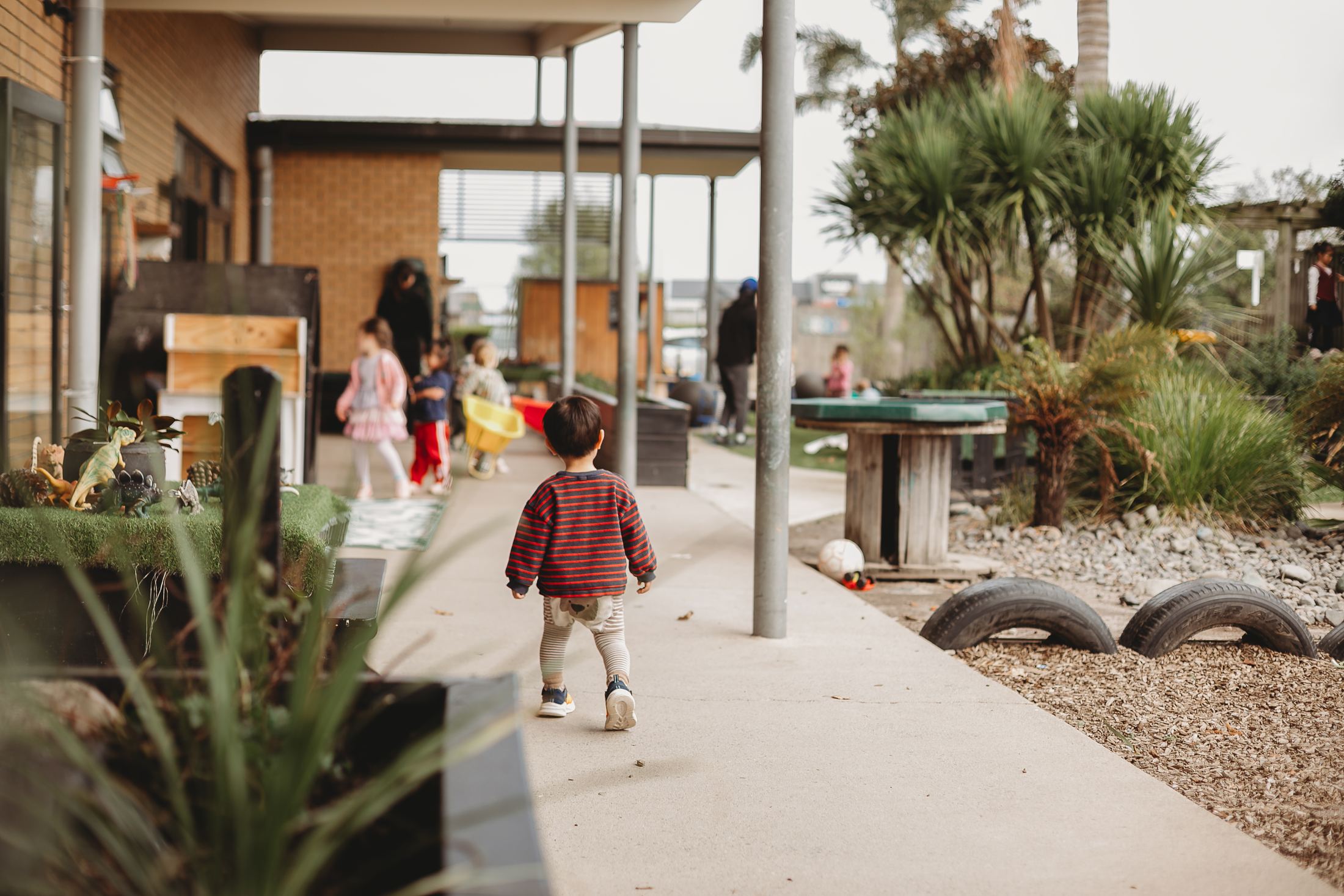 A child walking along the path through the centre's outdoor spaces